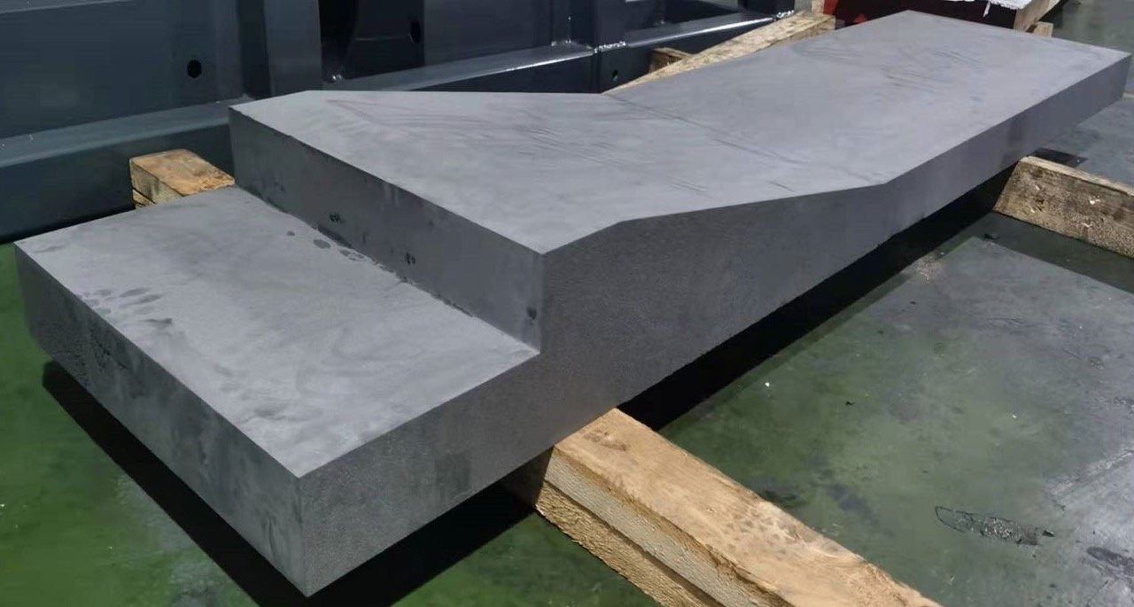 Graphite Cutting Solution Graphite block cutting process: Large graphite stock and a separated section on supports
